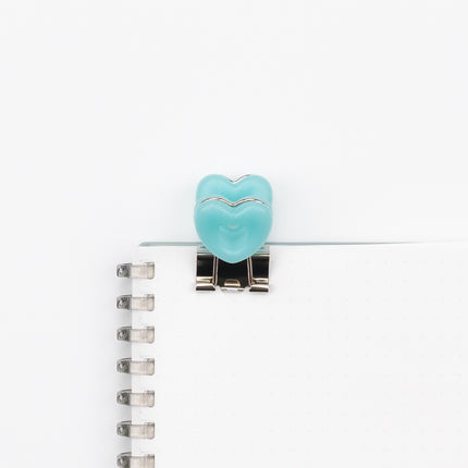 VELOS Heart Shape Clip on a notebook
