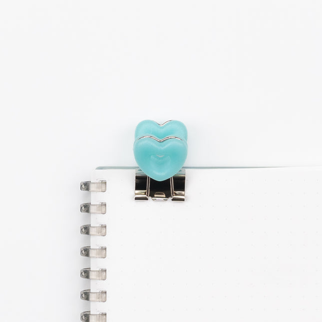 VELOS Heart Shape Clip on a notebook